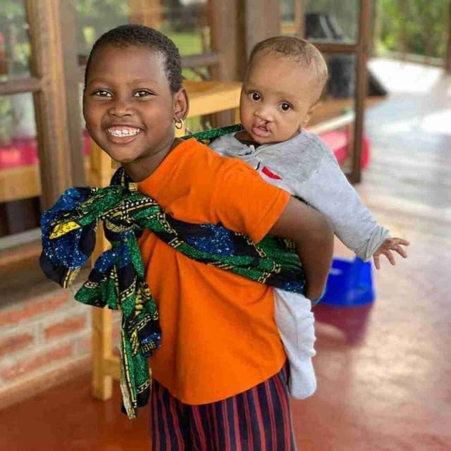 Employees at Kafika House helping children