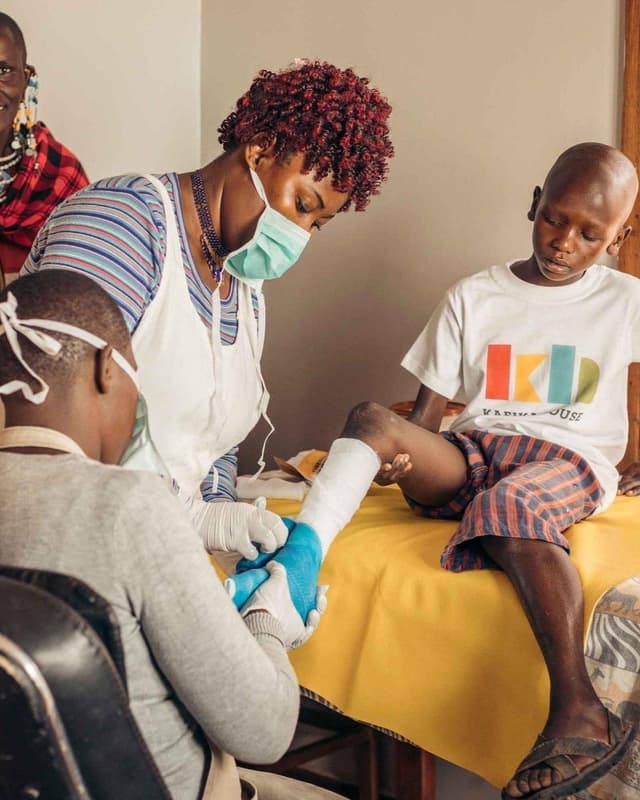 Employees at Kafika House helping children