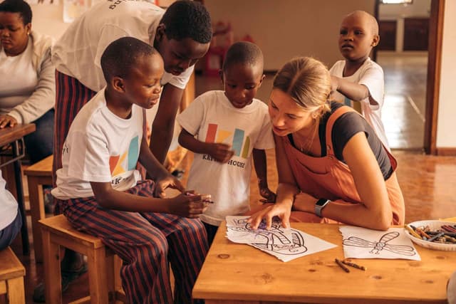 Employees at Kafika House helping children