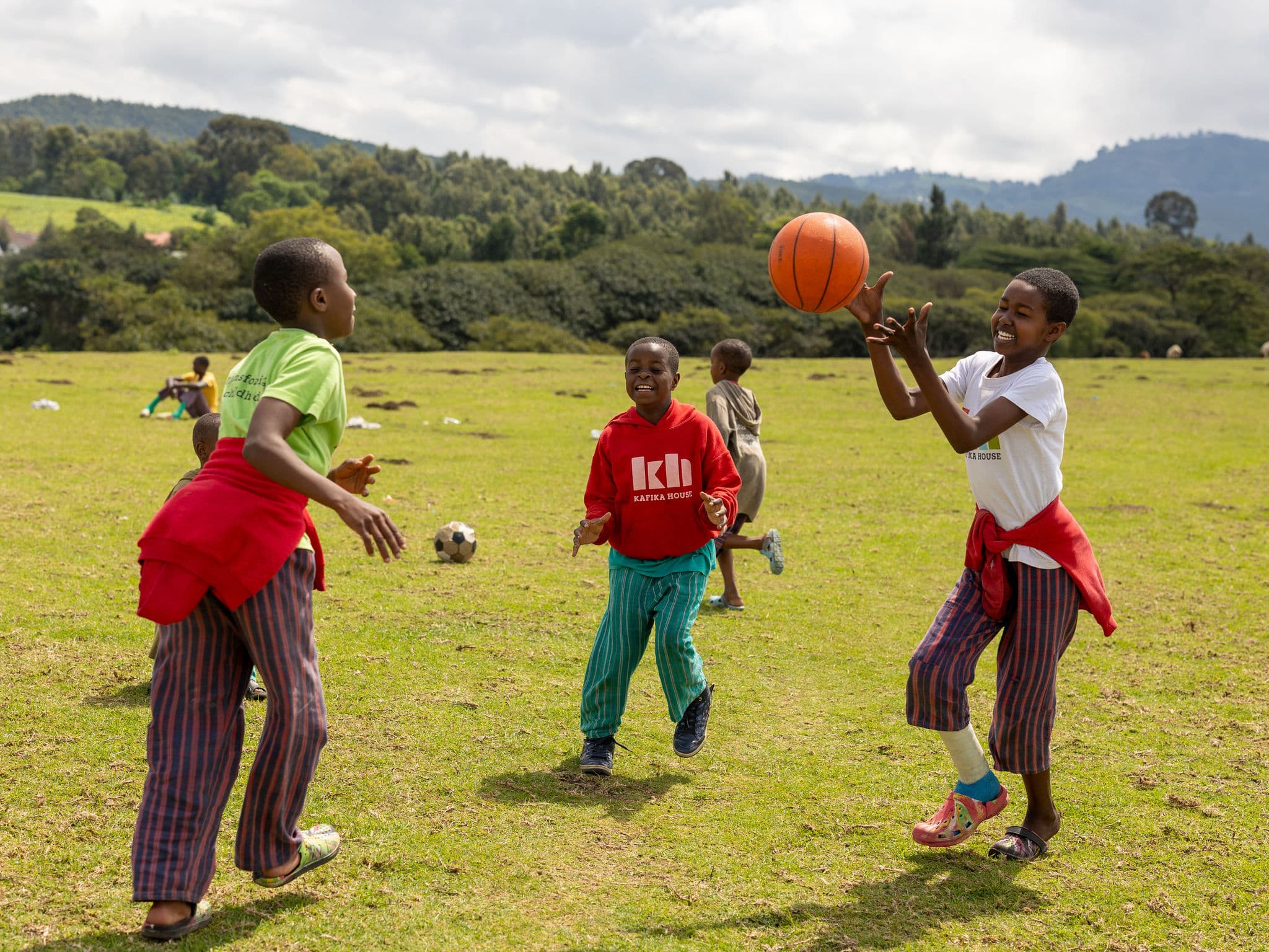 Employees at Kafika House helping children