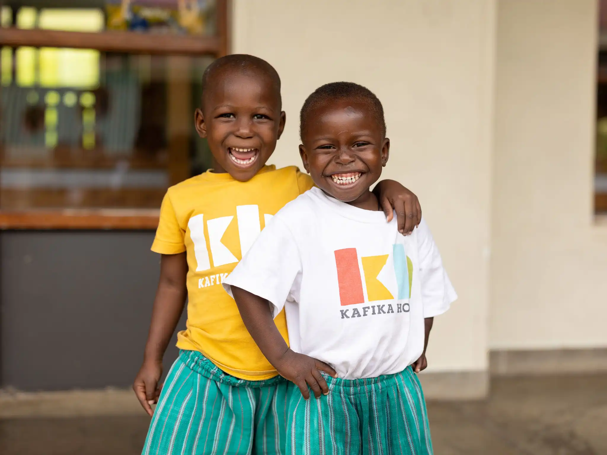 Employees at Kafika House helping children